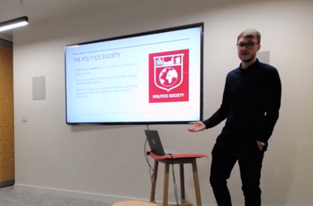 A picture of Will Hitt, the President of the Politics Society addressing the audience of the Make Votes Matter event.