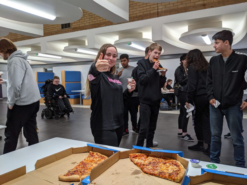 Committee member Theodora and Politics Society members enjoying their free pizza!